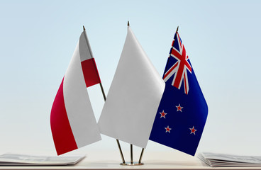 Flags of Poland and New Zealand with a white flag in the middle