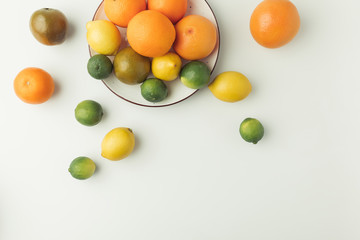 Naklejka na ściany i meble Citrus fruits on plate isolated on white background