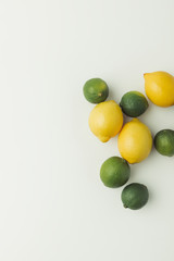 Green limes and yellow lemons isolated on white background