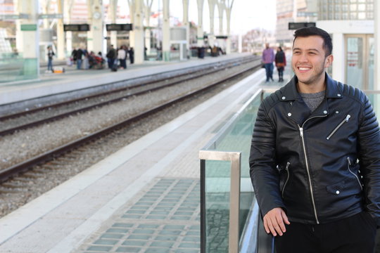 Smiley young ethnic male using public transportation