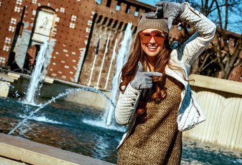 Plakat woman near Sforza Castle in Milan, Italy framing with hands