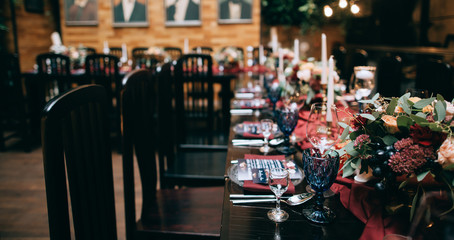 beautiful weding table decoration with red fresh flowers and candles