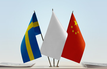 Flags of Sweden and China with a white flag in the middle