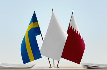 Flags of Sweden and Qatar with a white flag in the middle