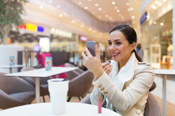 Woman drinking coffee in cafe
