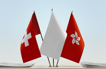 Flags of Switzerland and Hong Kong with a white flag in the middle
