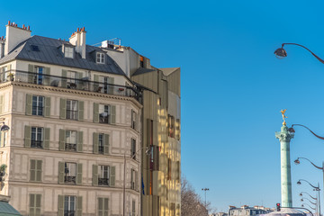 Fototapeta na wymiar Paris, typical facade near Bastille, the statue of the golden angel in background 