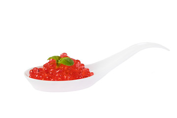 Plastic spoons with fish caviar on a white background. 