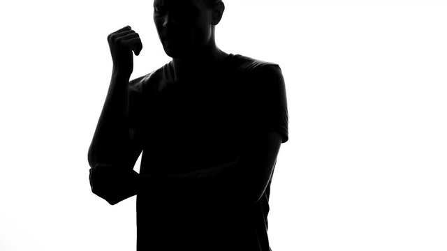 Athlete male shadow holding his elbow, feeling joint inflammation, sport injury