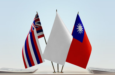 Flags of Hawaii and Taiwan with a white flag in the middle