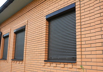 House Windows with rolling shutters for home protection.