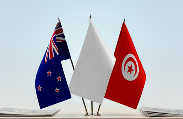 Flags of New Zealand and Tunisia with a white flag in the middle