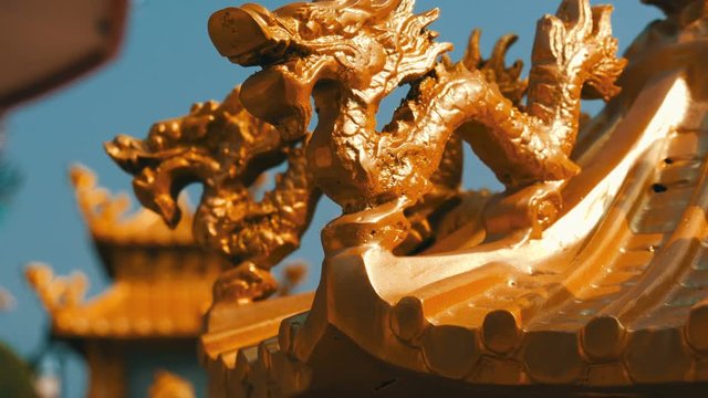 Golden statue of the Chinese dragon in the temple complex. Ornament and decoration in Chinese temple