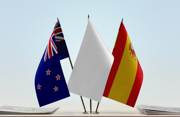 Flags of New Zealand and Spain with a white flag in the middle