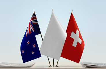 Flags of New Zealand and Switzerland with a white flag in the middle