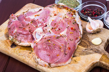 Obraz premium Turkey meat with spices and herbs on cutting board