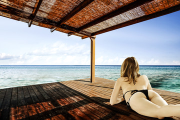 woman in bikini on terrace and summer time 