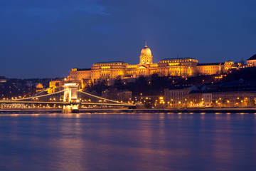 Illuminated Royal Palace in Budapest across Danube river at night