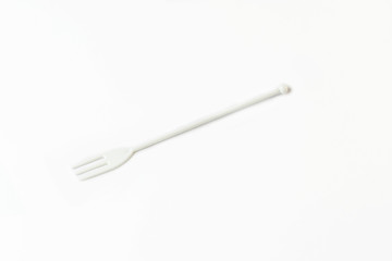 Miniature plastic utensils for snacks and canaps on a white background 