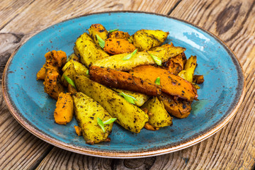 Baked vegetables, potatoes and pumpkin with herbs and spices