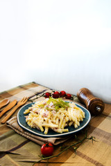 Italian food macaroni gratin with ham on table