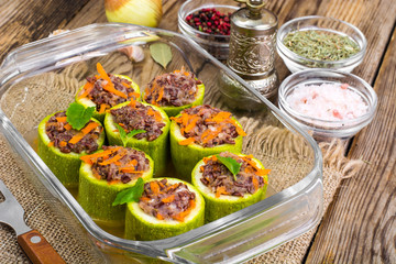 Vegetarian dish. Raw zucchini stuffed with red rice with vegetables