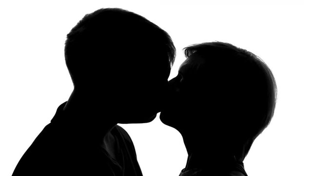 Young couple silhouette kissing on romantic date, love passion, tender feelings