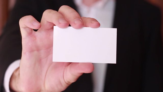 Blank business card showed by businessman
