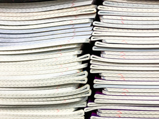 Pile of school notebooks on  shelf