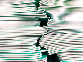 Pile of school notebooks on  shelf