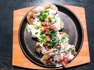 Potato pancakes, sour cream, bacon, greens