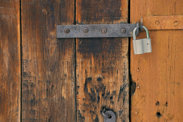 texture of old wooden door with metal lock