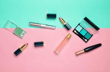 Female cosmetics for make-up layout on a pastel background. Cosmetic shadows, make-up brush,...