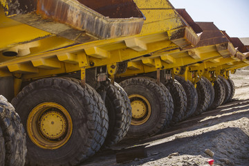 Dumper trucks parked on a construction site.
