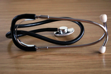 Stethoscope on wooden background or vintage table. Selective focus, the concept of a rural doctor....