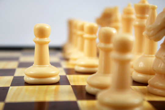 Chess Figure, Business Concept Strategy, Leadership, Team And Success. Leadership, Confidence And Imagination Concept. Chess Game Player Makes A Move The White Pawn One Step Forward.