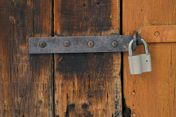 texture of old wooden door with metal padlock