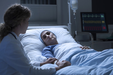 Nurse supporting woman with leukemia