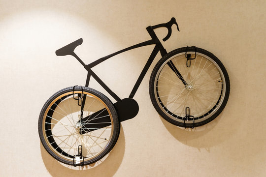 Modern living room with wooden stylish bicycle hanging on wall