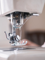 Girl working on sewing machine with textile napkins