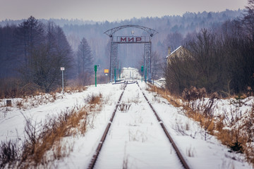 Word Peace on a gate of old railroad bridge near Gobiaty village on the border between Poland and...
