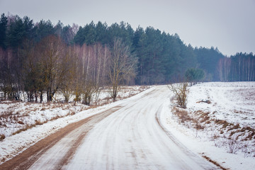 Country road covered with snow in Podlasie region of eastern Poland