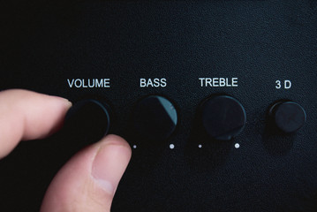 Hand on Sound volume control knob