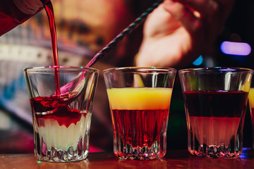 Barman or bartender preparing alcohol cocktail in restaurant