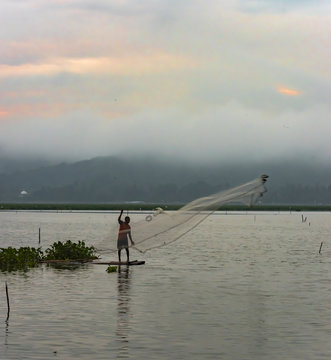 Fisherman spreading the web view in early morning. Location JOMBOR water dam, Central Java, Klaten, Yogyakarta