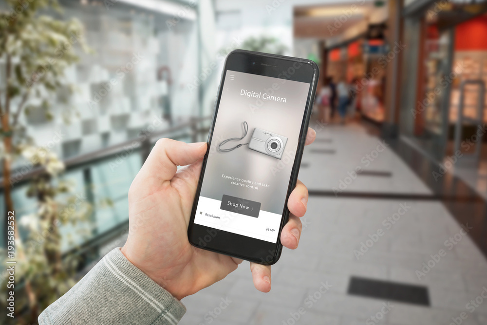 Poster shopping technological products with web site on smart phone display. shopping mall in background.