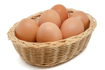 Eggs in the wicker basket on white background for healthy food concept
