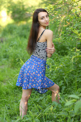 Naklejka na ściany i meble girl on a background of a green summer meadow