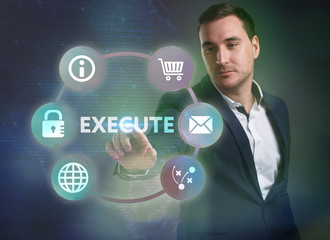 Business, Technology, Internet and network concept. Young businessman working on a virtual screen of the future and sees the inscription: Execute