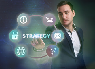 Business, Technology, Internet and network concept. Young businessman working on a virtual screen of the future and sees the inscription: Strategy
